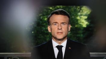 Illustration of French President Emmanuel Macron speaking during a televised address to the nation during which he annou
