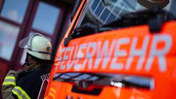 ILLUSTRATION - 08.11.2023, Baden-Württemberg, Stuttgart: Eine Einsatzkraft der Feuerwehr steht neben einem Einsatzfahrzeug der Feuerwehr. (zu dpa: «100.000 Euro Schaden bei Brand in Park») Foto: Marijan Murat/dpa +++ dpa-Bildfunk +++