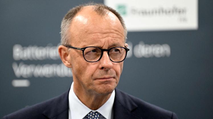 German Chancellor Friedrich Merz looks on during a visit at the Fraunhofer Research Institution for Battery Cell Production FFB in Muenster, western Germany on September 1, 2025, as part of his first official visit as Chancellor to the western federal state of North Rhine-Westphalia. (Photo by INA FASSBENDER / AFP)