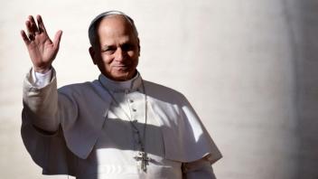 Pope Leo XIV waves to the crowd as he arrives during the weekly general audience at St Peter's Square at the Vatican, on December 10, 2025. (Photo by TIZIANA FABI / AFP)