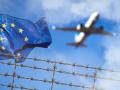 Bavaria, Germany - November 16, 2025: PHOTO MONTAGE, EU flag, barbed wire, and a passing airplane symbolize entry and ex