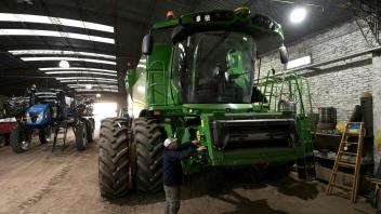 An employee of "Guanzini Hermanos S.A." checks a combine sprayer at Cucullu, a small town near the rural town of San Andres de Giles in Buenos Aires province, Argentina on September 24, 2025. Surrounded by wheat fields and dozing during siesta time, the farming town of San Andres de Giles voted for Javier Milei in 2023. Two years later, the enthusiasm has faded into disappointment and uncertainty, ahead of a crucial legislative election for the Argentine president. (Photo by JUAN MABROMATA / AFP)